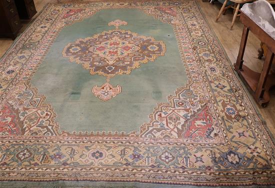 A Turkish green medallion carpet (worn in places and with one burn mark) 416cm x 300cm